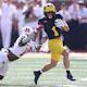Roman Wilson #1 of the Michigan Wolverines looks for yards after a first half catch as we make our predictions for the 2024 NFL Draft Combine odds and props.