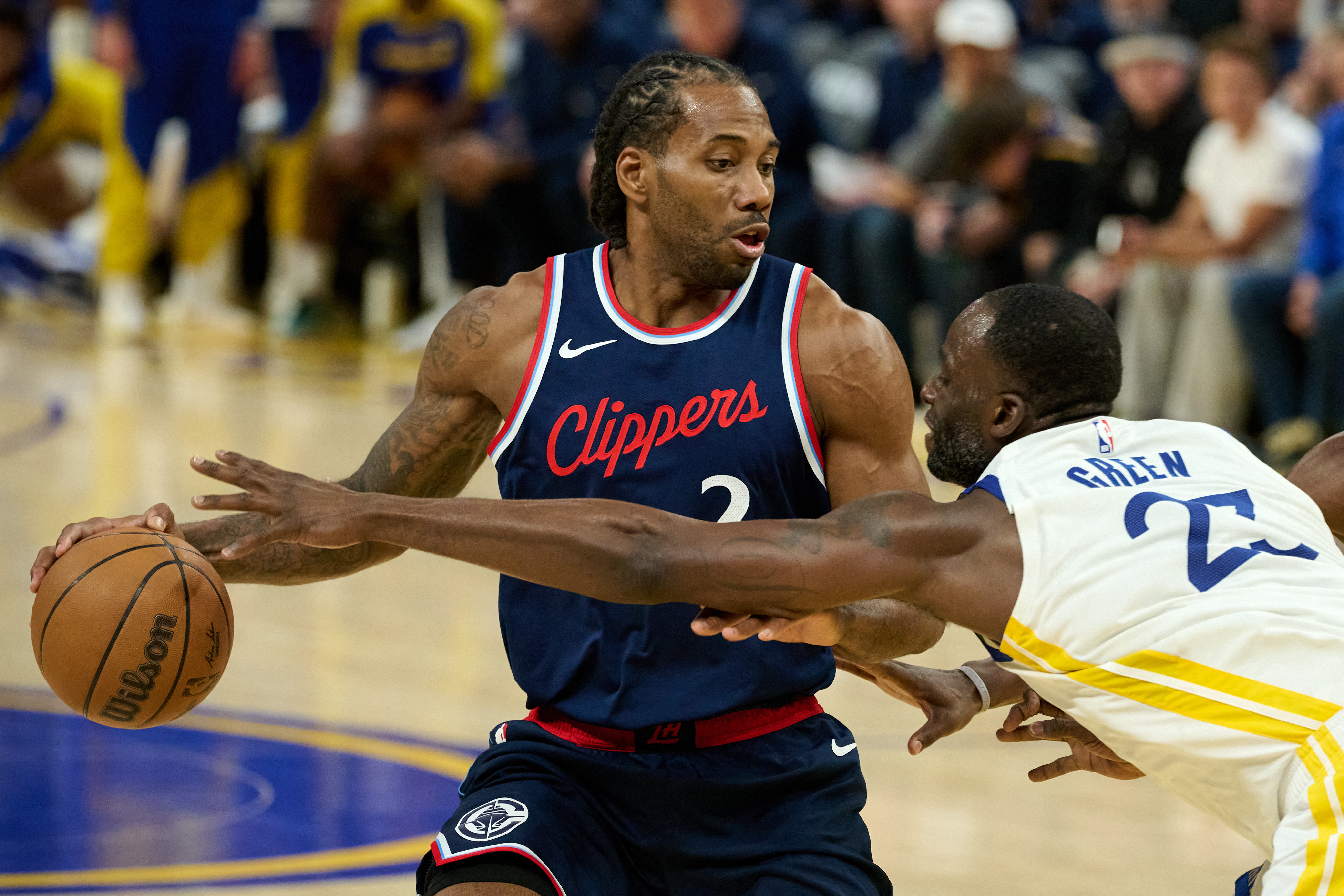 Warriors forward Draymond Green (23) extends for the ball against Clippers forward Kawhi Leonard (2) as we explore the best Warriors vs. Clippers player props.