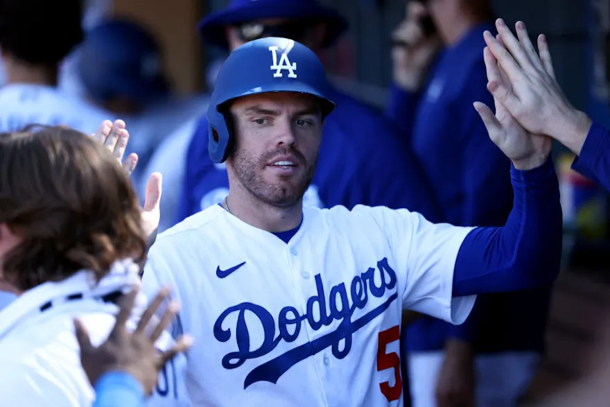 Freddie Freeman of the Los Angeles Dodgers celebrates his run scored with teammates in the dugout during the eighth inning against the Arizona Diamondbacks.