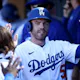 Freddie Freeman of the Los Angeles Dodgers celebrates his run scored with teammates in the dugout during the eighth inning against the Arizona Diamondbacks.