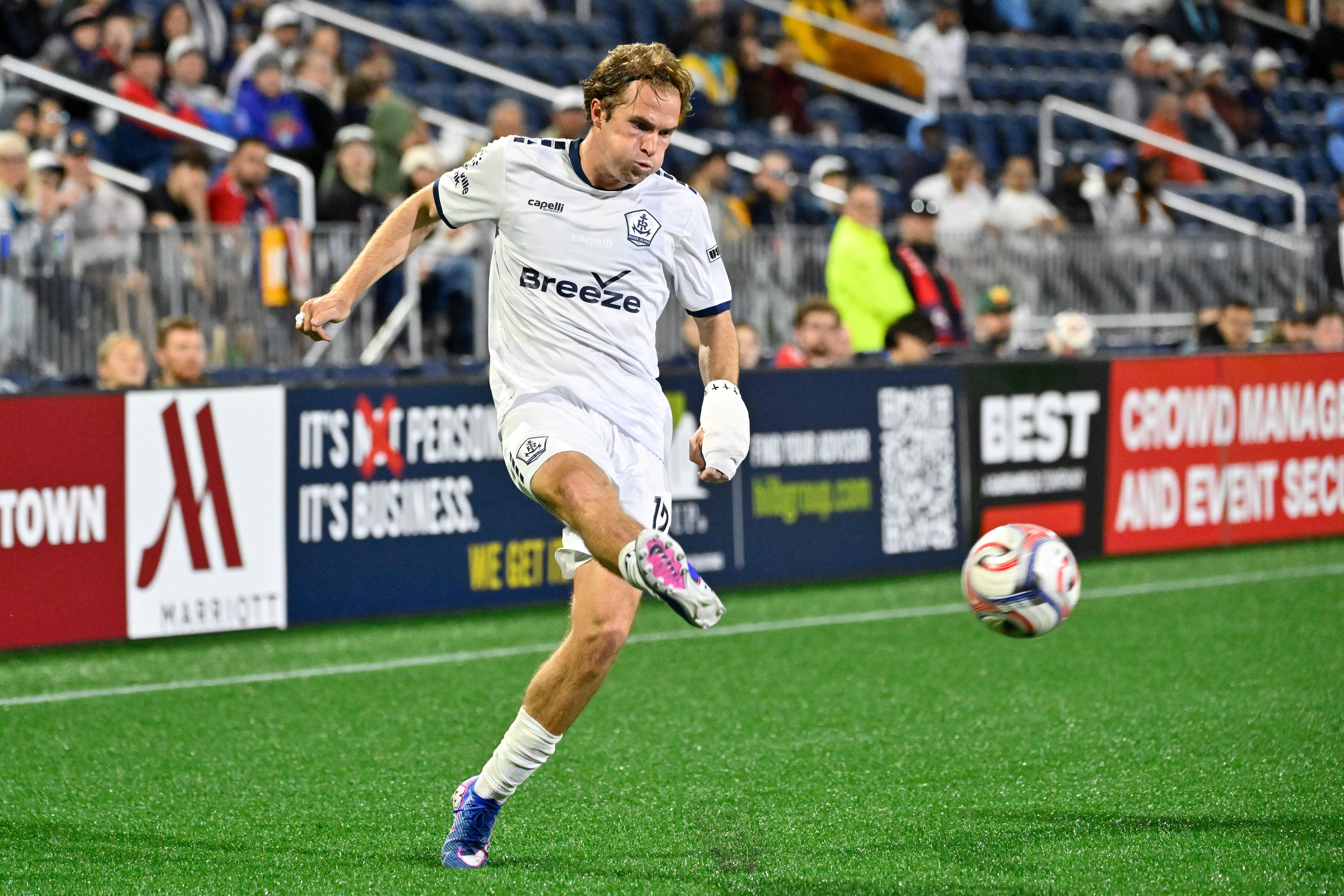 Rhode Island FC midfielder Clay Holstad kicks the ball as we look at possible sports betting expansion in the state