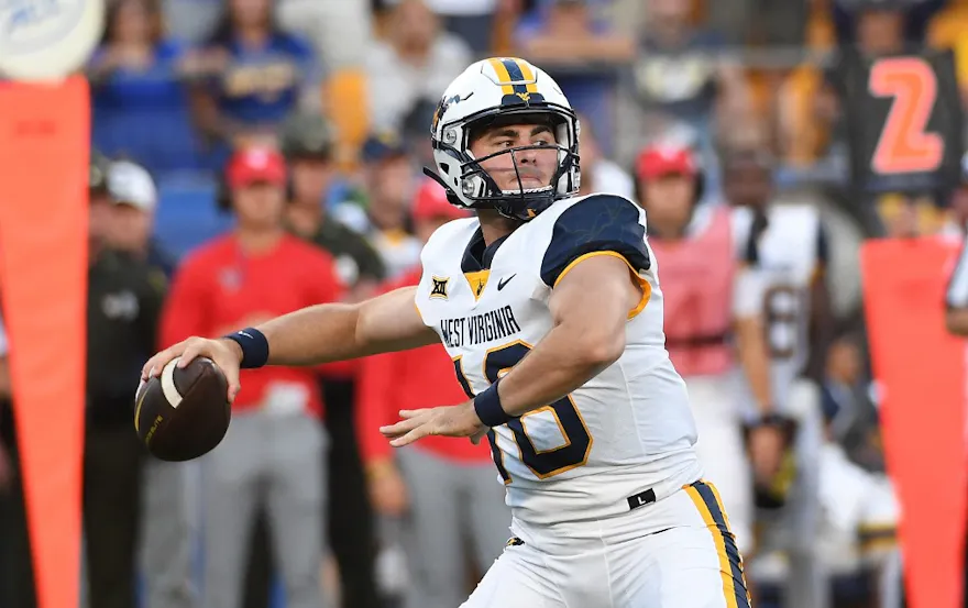 JT Daniels #18 of the West Virginia Mountaineers drops back to pass in the first quarter during the game against the Pittsburgh Panthers at Acrisure Stadium on Sept. 1.