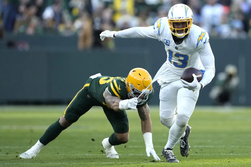 Keenan Allen of the Los Angeles Chargers runs with the ball as part of our Week 12 NFL predictions for Ravens vs. Chargers