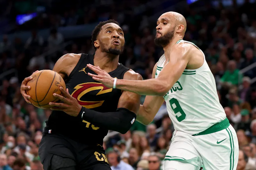 Donovan Mitchell (45) of the Cleveland Cavaliers drives to the basket against Derrick White (9) of the Boston Celtics, as we offer our best Cavaliers vs. Celtics player props for Game 2 on Thursday at TD Garden in Boston.