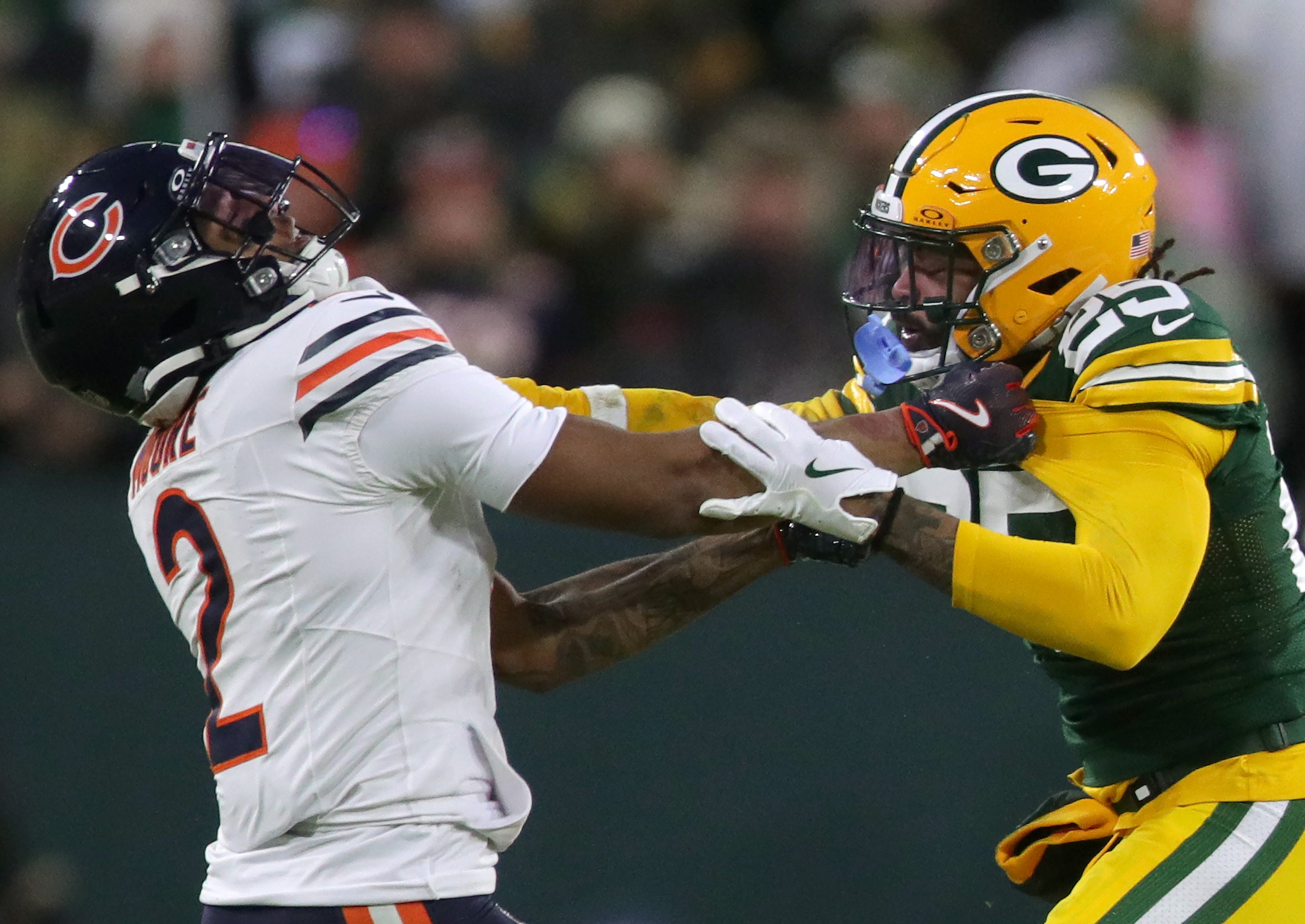 Bears wide receiver DJ Moore (2) and Packers cornerback Keisean Nixon (25) grab each other as we break down the NFL weather report for Week 16.