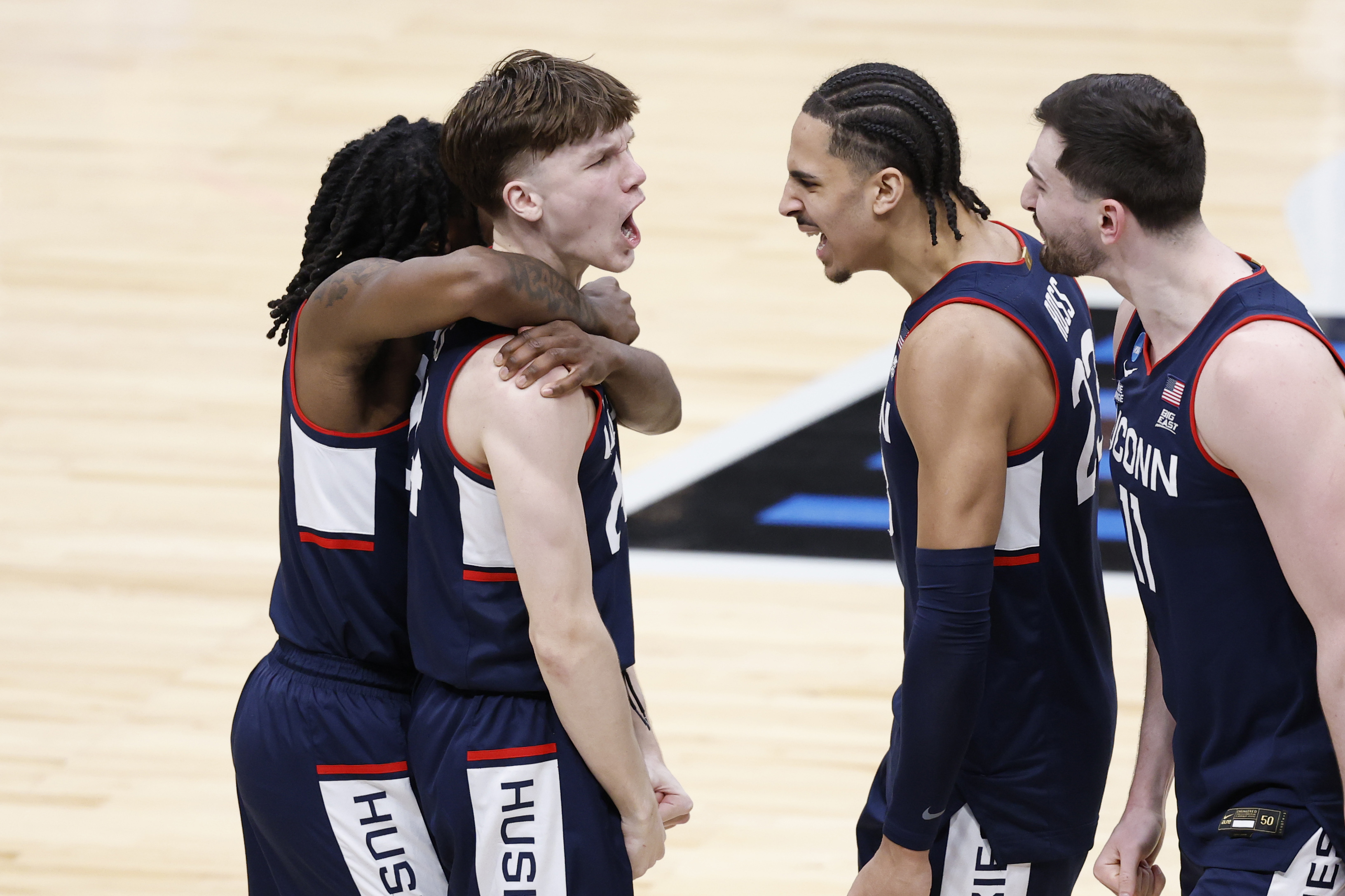 UConn Huskies guard Braylon Mullins (24) celebrates with teammates after scoring the game winning basket against Duke in the Elite Eight.