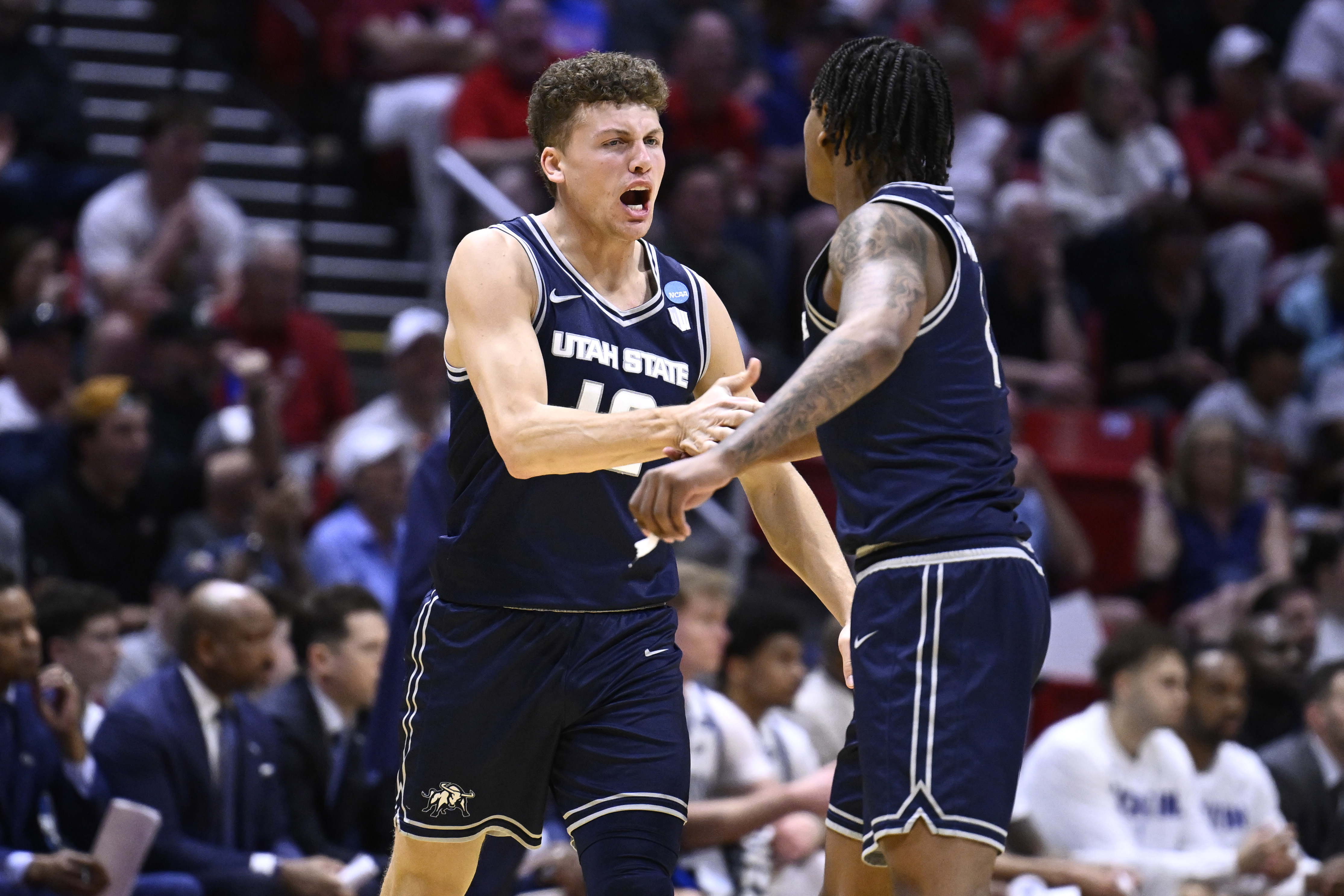 Utah State guards Mason Falslev (12) and Elijah Perryman (1) react as we break down our Utah State vs. Arizona prediction.