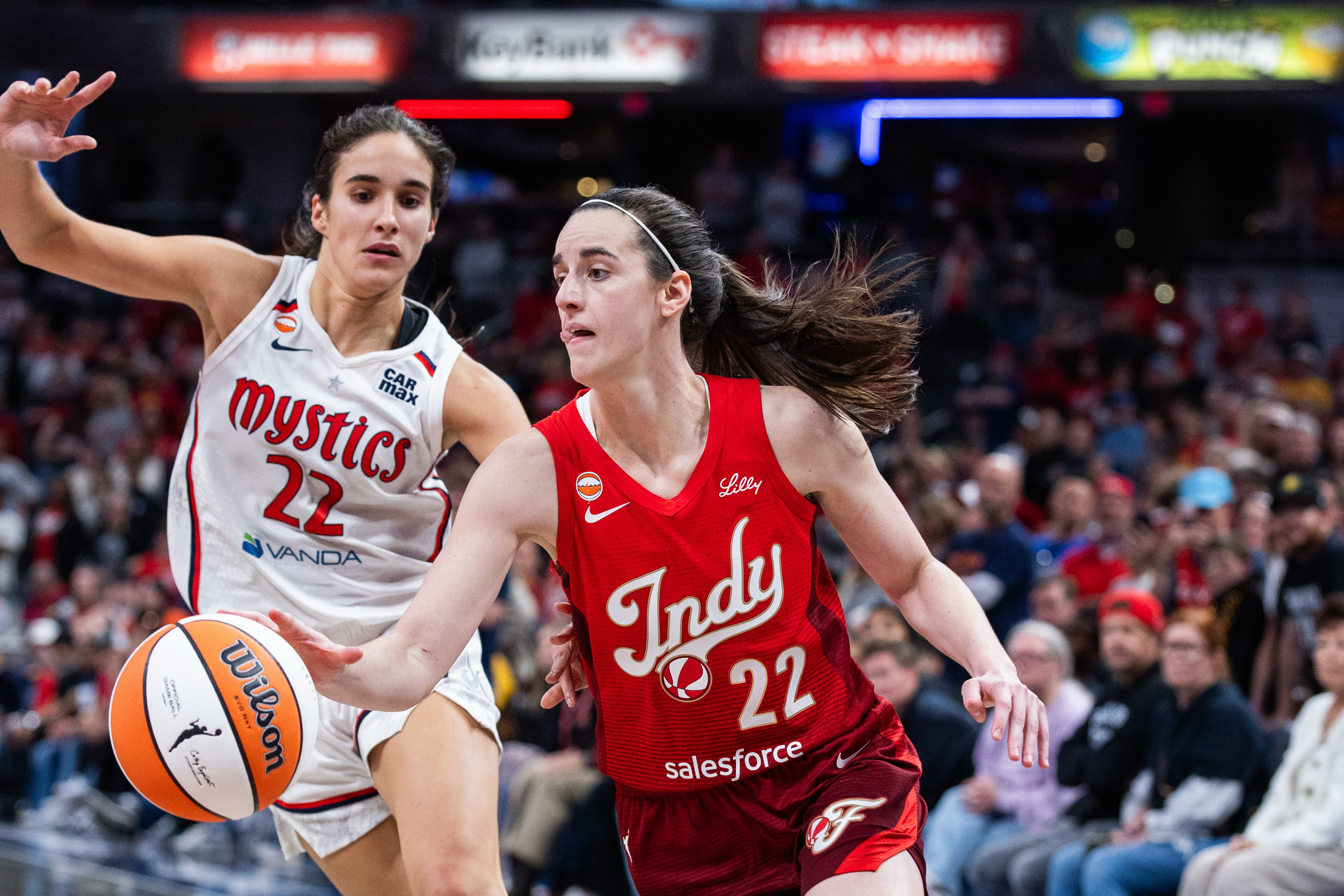 Indiana Fever guard Caitlin Clark (22), seen here dribbling during a game, is featured in our Fever vs. Mystics prediction.
