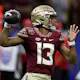 Quarterback Jordan Travis of the Florida State Seminoles throws a pass as we look at the latest ACC conference odds.