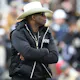 Head coach Deion Sanders of the Colorado Buffaloes watches as his team warms up as we look at our Colorado betting preview