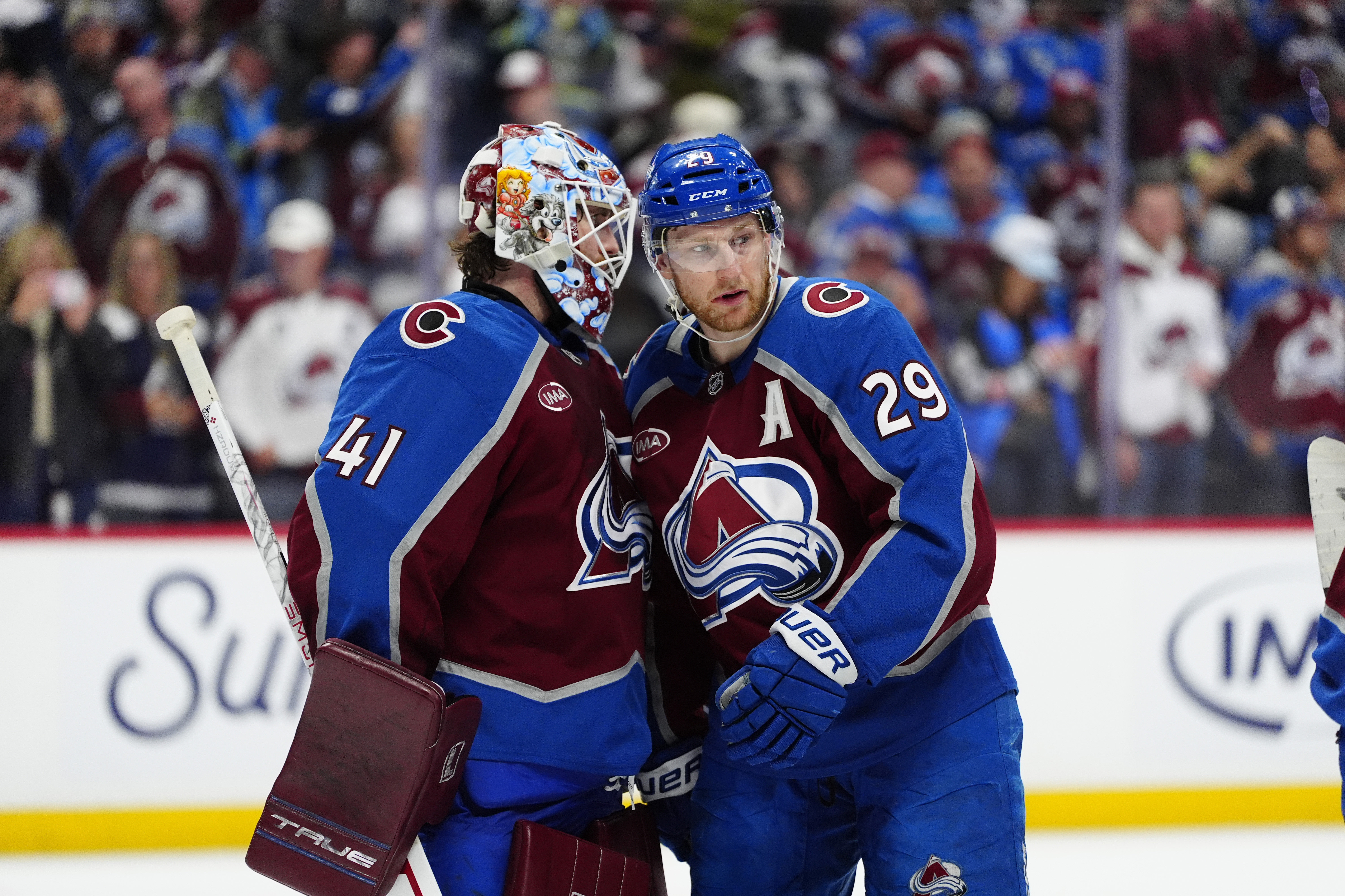 Colorado Avalanche goaltender Scott Wedgewood (41) and center Nathan MacKinnon (29) celebrate defeating the Minnesota Wild in game one of the second round of the 2026 Stanley Cup Playoffs at Ball Arena. 
