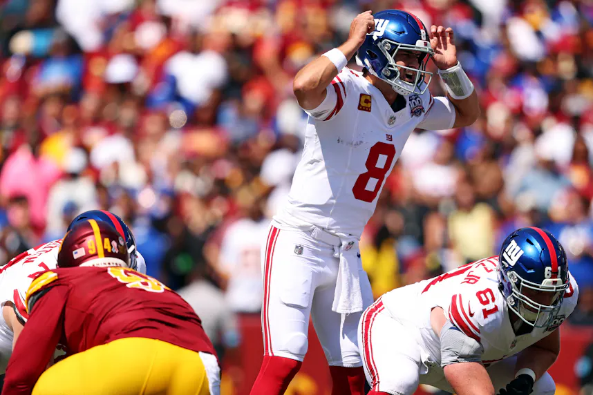 New York Giants quarterback Daniel Jones signals at the line of scrimmage as we dive into our best Giants vs. Cowboys prop bets.