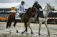 Jockey Brian Hernandez Jr. rides Mystik Dan as they are walked to the starting line ahead of the 149th running of the Preakness Stakes at Pimlico Race Course as we look at our triple crown odds. 