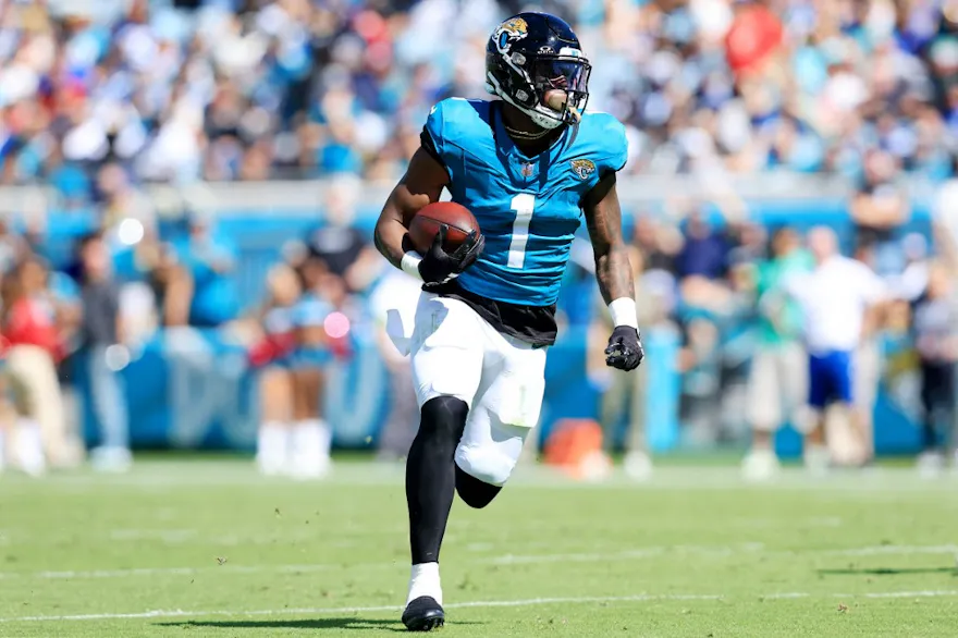 Travis Etienne Jr. of the Jacksonville Jaguars runs with the ball as we share our best Ravens vs. Jaguars parlay predictions for SNF.