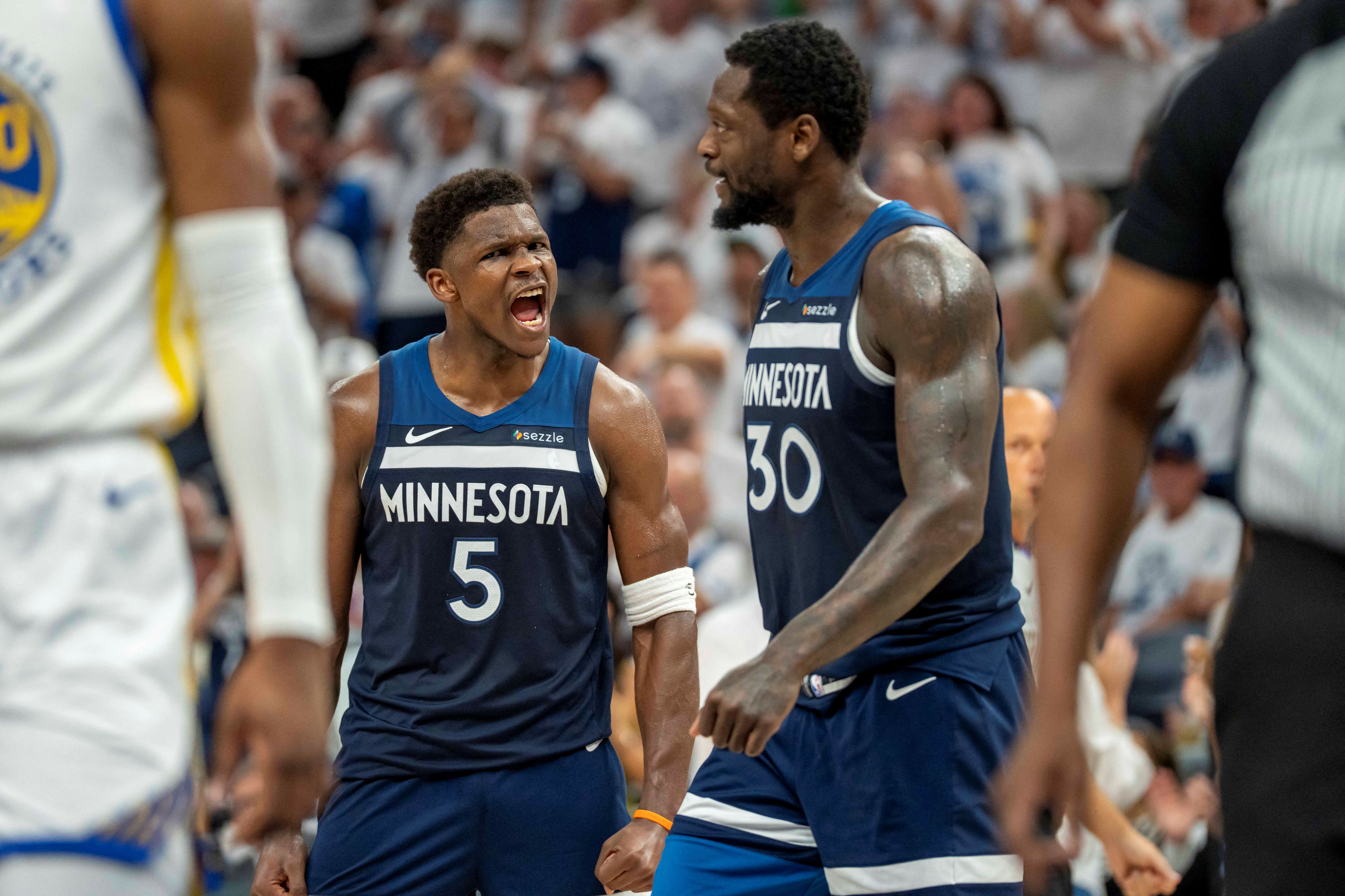 Minnesota Timberwolves guard Anthony Edwards (5) celebrates with forward Julius Randle, and both are featured in our Warriors vs. Timberwolves player props for Monday, Jan. 26.