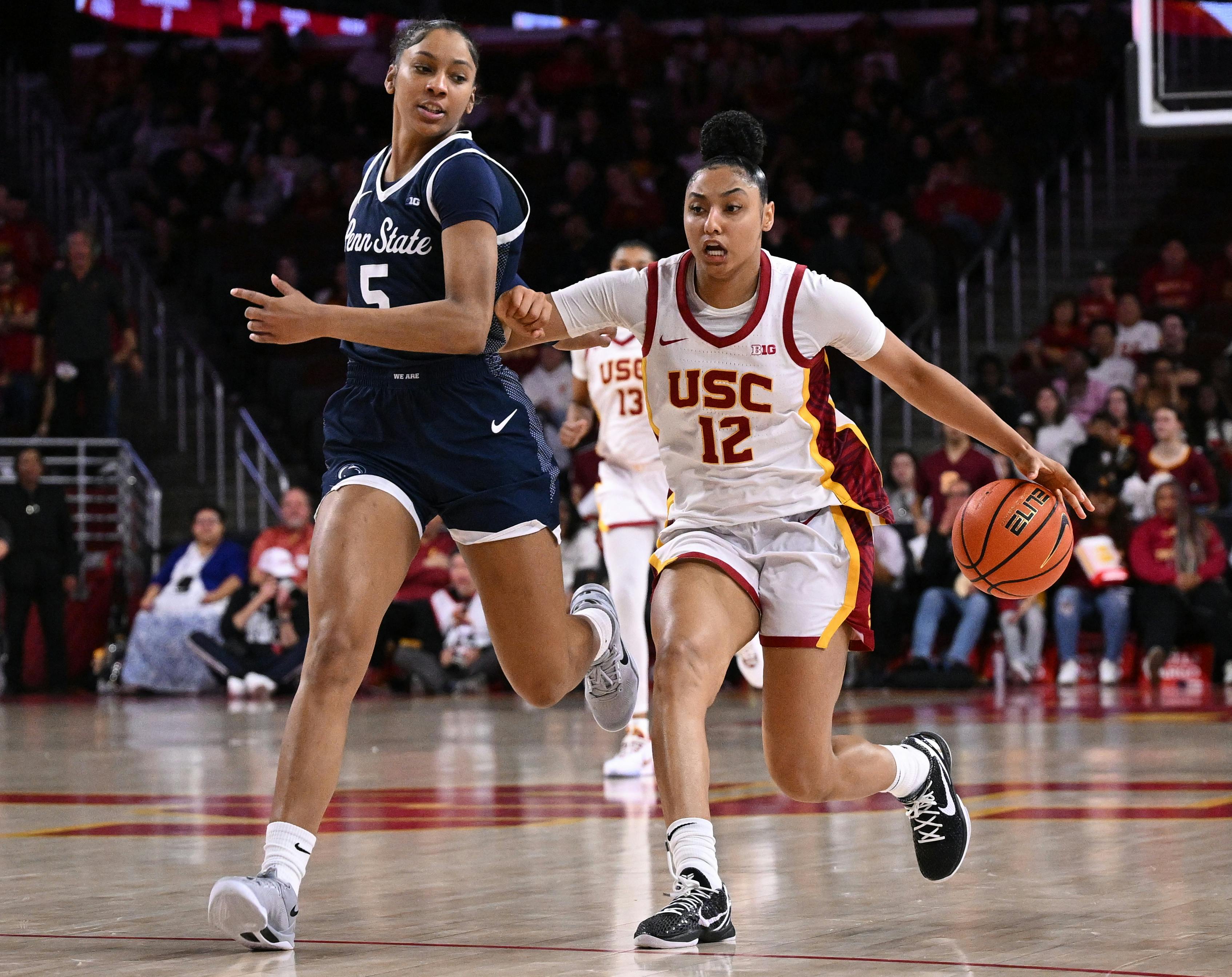 USC guard JuJu Watkins dribbles the ball down the court past Penn State forward Tamera Johnson. The Trojans are among the Women