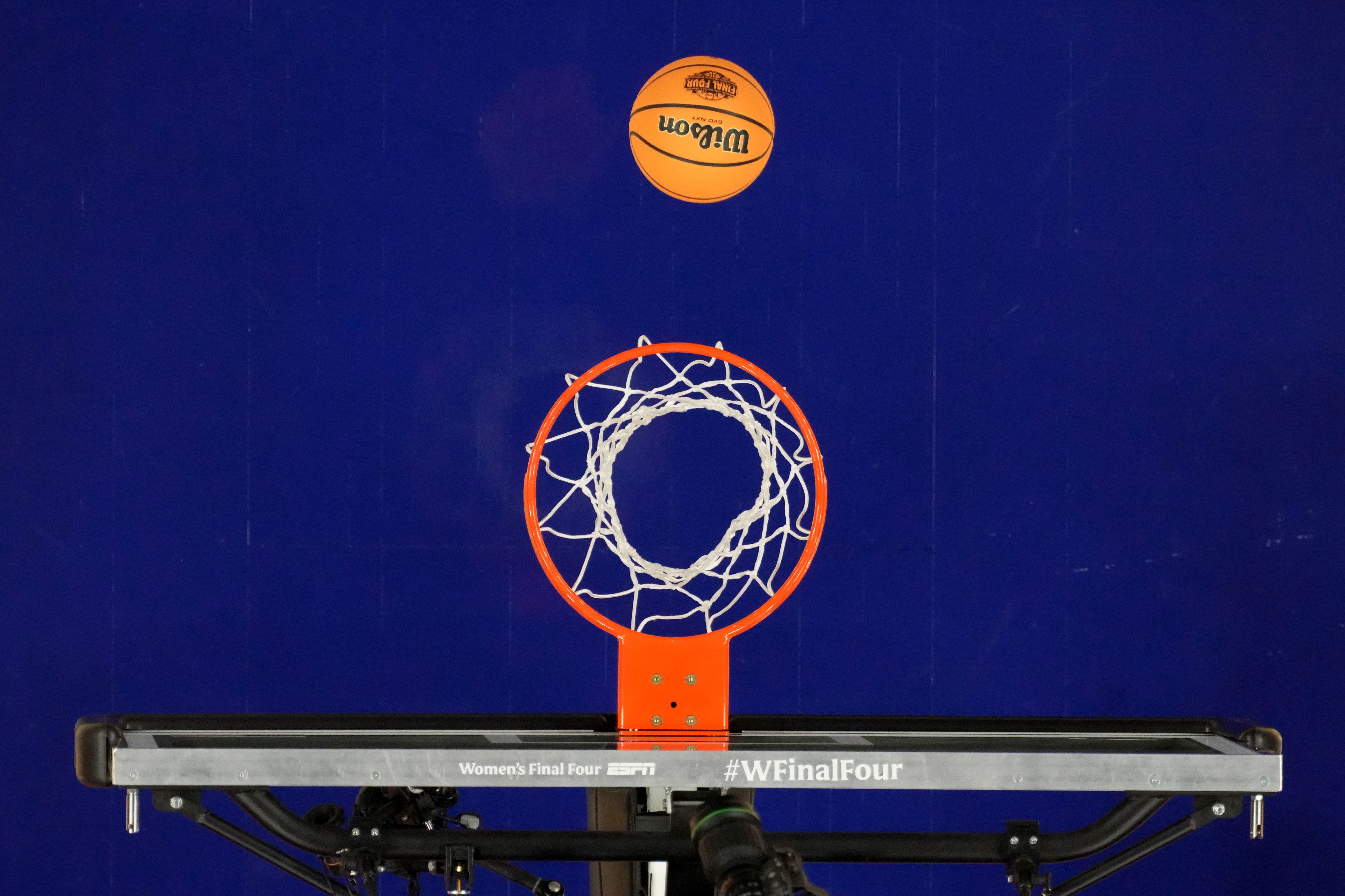 A Wilson Evo NXT basketball with the Final Four logo approaches the rim as we look at the NCAA asking for prediction markets not to have college sports.