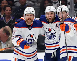 Ryan Nugent-Hopkins and Brett Kulak congratulate Leon Draisaitl of the Edmonton Oilers after his goal against the Los Angeles Kings, and we offer our top Oilers vs. Kings predictions and expert picks based on the best NHL odds.