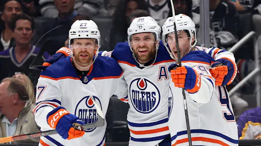 Ryan Nugent-Hopkins and Brett Kulak congratulate Leon Draisaitl of the Edmonton Oilers after his goal against the Los Angeles Kings, and we offer our top Oilers vs. Kings predictions and expert picks based on the best NHL odds.