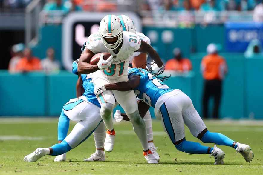 Raheem Mostert rushes the football as part of our Week 16 NFL predictions and best bets for Cowboys vs. Dolphins.