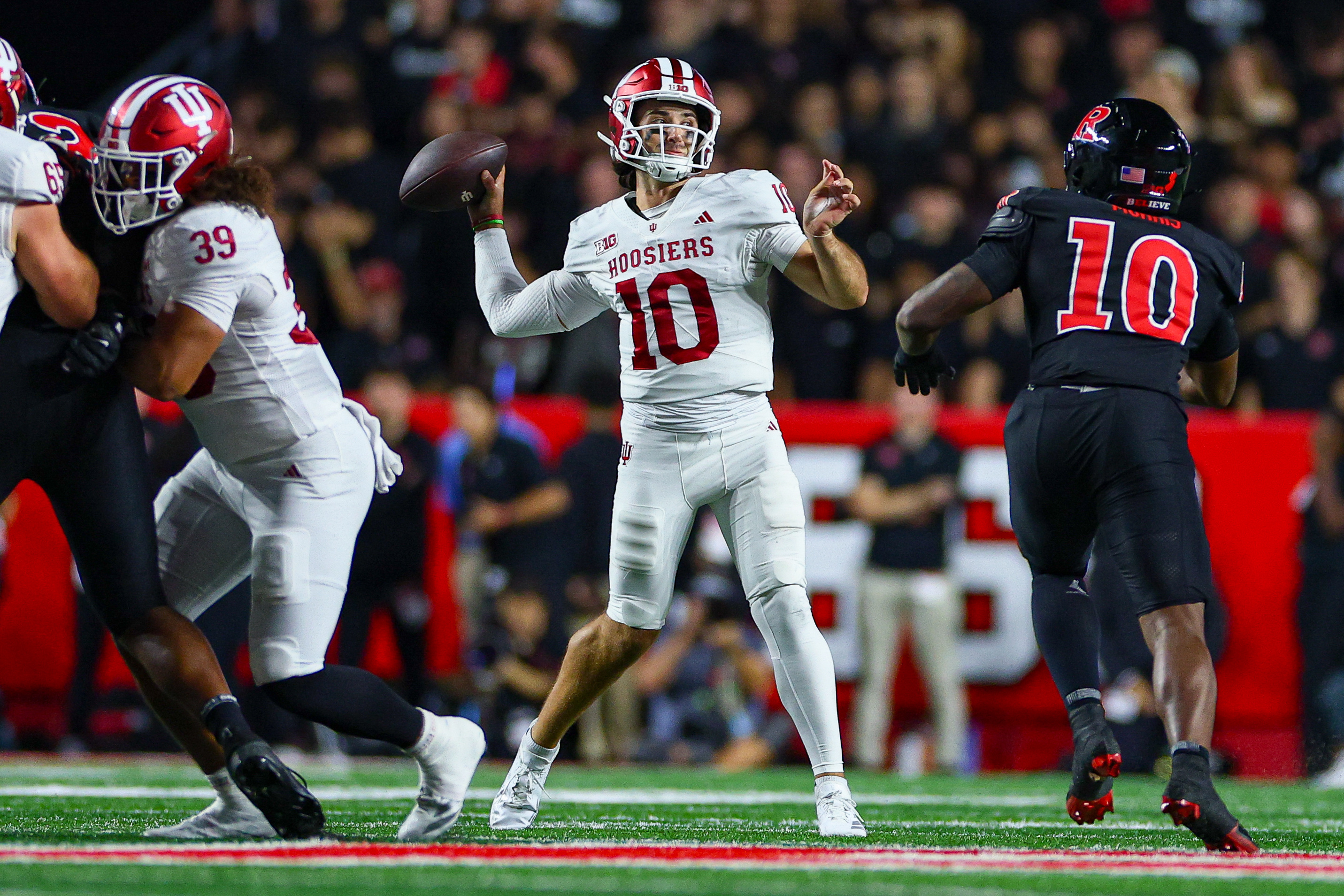 Pictured: Hoosiers quarterback Josh Hoover throwing a pass as we break down our Ohio State vs. Indiana Prediction. Photo by Vincent Carchietta-Imagn Images.