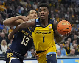 Kam Jones of the Marquette Golden Eagles dribbles the ball against Tae Davis of the Notre Dame Fighting Irish during the first half at Fiserv Forum as we look at our NC State-Marquette prediction.