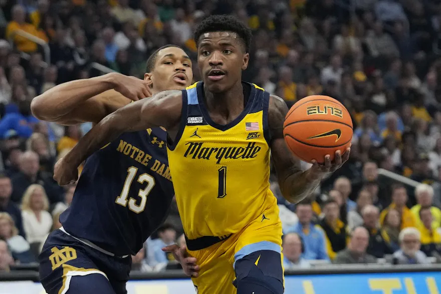 Kam Jones of the Marquette Golden Eagles dribbles the ball against Tae Davis of the Notre Dame Fighting Irish during the first half at Fiserv Forum as we look at our NC State-Marquette prediction.