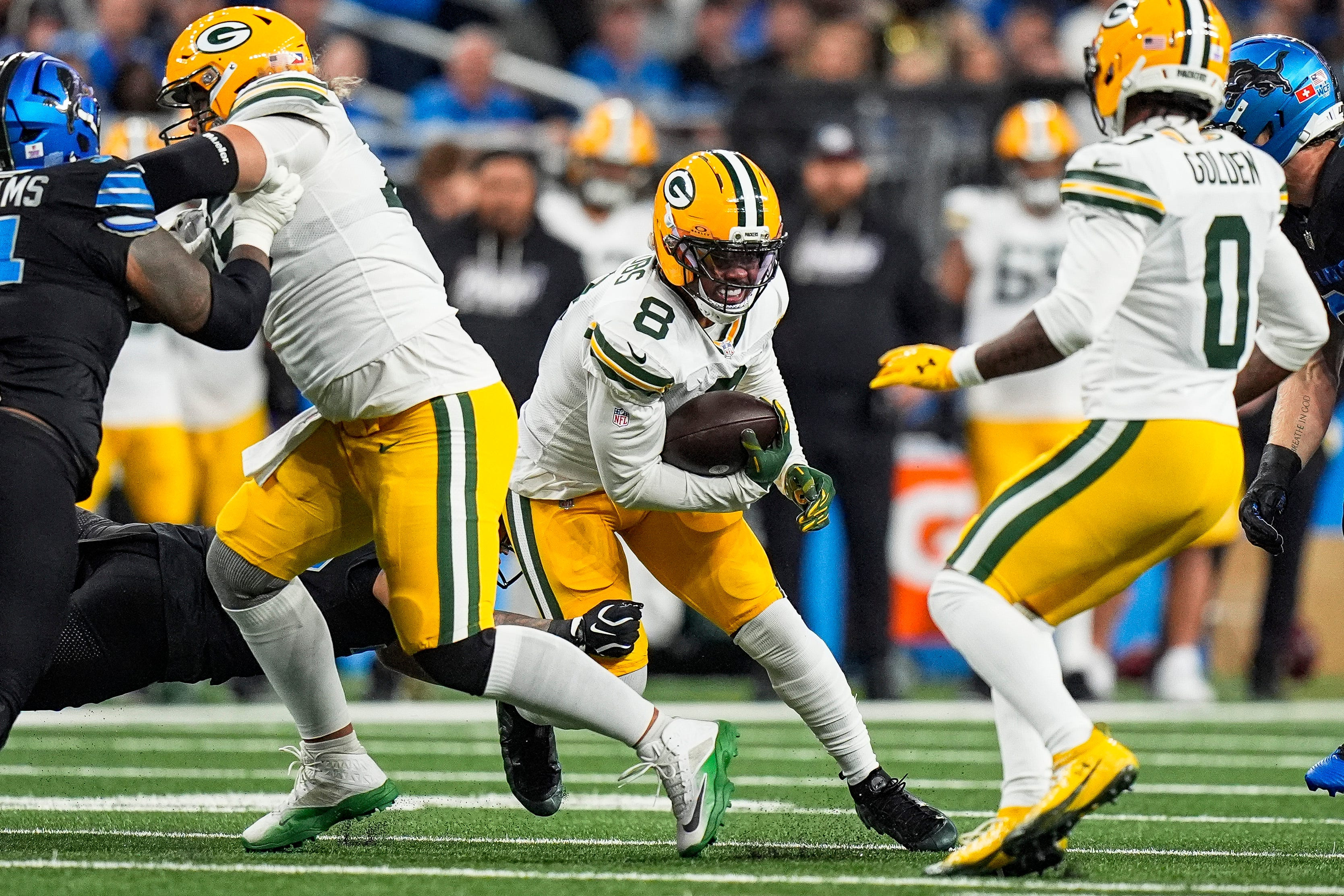 Green Bay Packers running back Josh Jacobs (8) runs as he is featured in our Panthers vs. Packers same-game parlay.