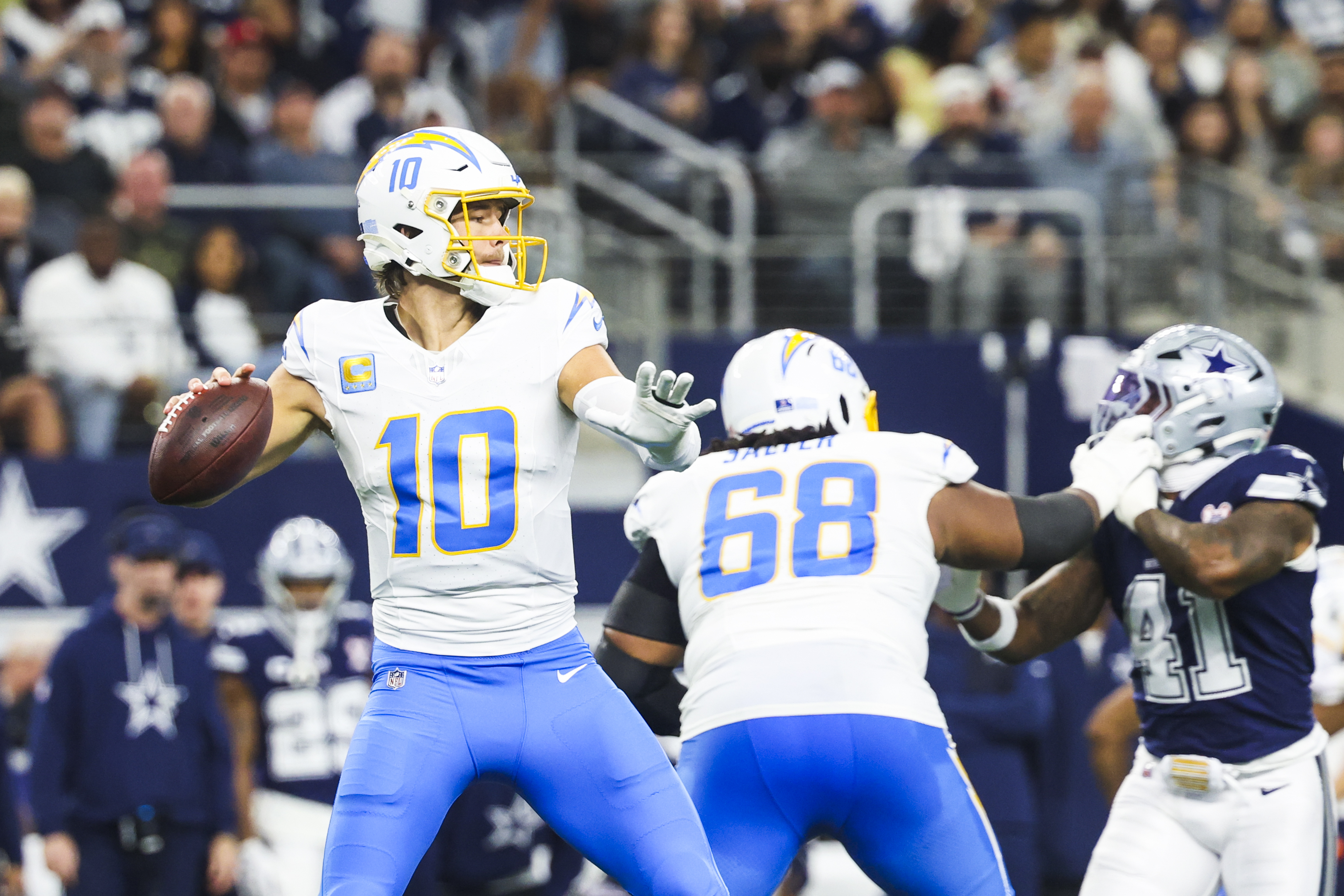 Los Angeles Chargers quarterback Justin Herbert (10) looks to pass as we look at our NFL predictions for Week 17