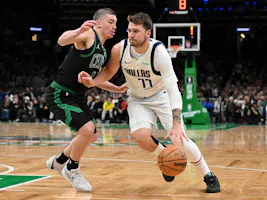 Luka Doncic (77) of the Dallas Mavericks drives to the basket against Payton Pritchard (11) of the Boston Celtics, as we offer our best Luka Doncic player props and expert picks for Thursday's Game 1 of the 2024 NBA Finals at TD Garden in Boston.