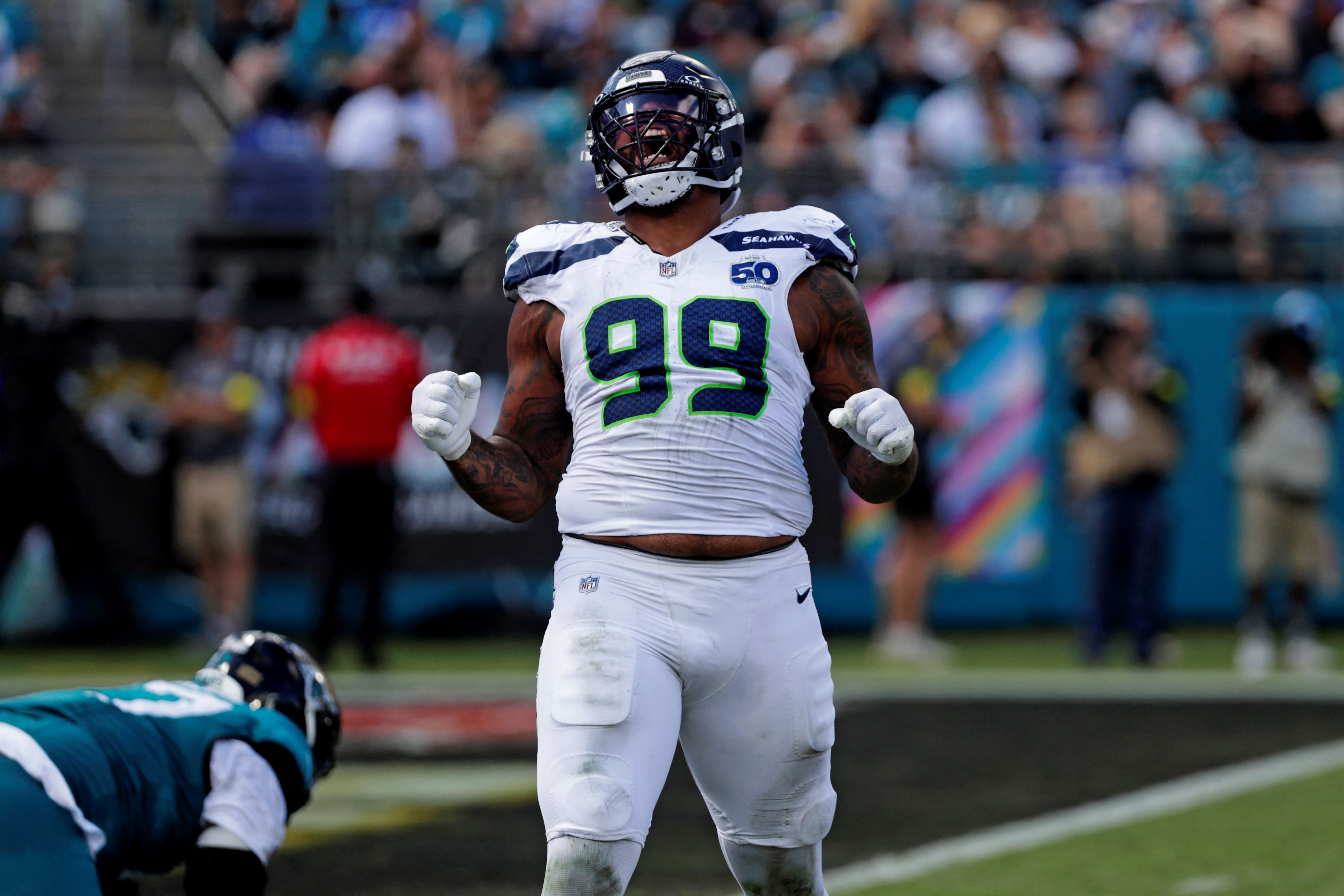 Seattle Seahawks defensive end Leonard Williams celebrates, and he's key as we look at our Super Bowl defensive player props.