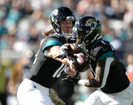 Trevor Lawrence #16 of the Jacksonville Jaguars hands the ball off to Travis Etienne Jr. #1 as we round up our NFL predictions for Week 13