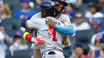 Ozzie Albies of the Atlanta Braves is hugged by Ronald Acuna Jr. after he hit a two-run home run in the seventh inning in Game 1 of a doubleheader at Citi Field as we look at our 2023 World Series odds.