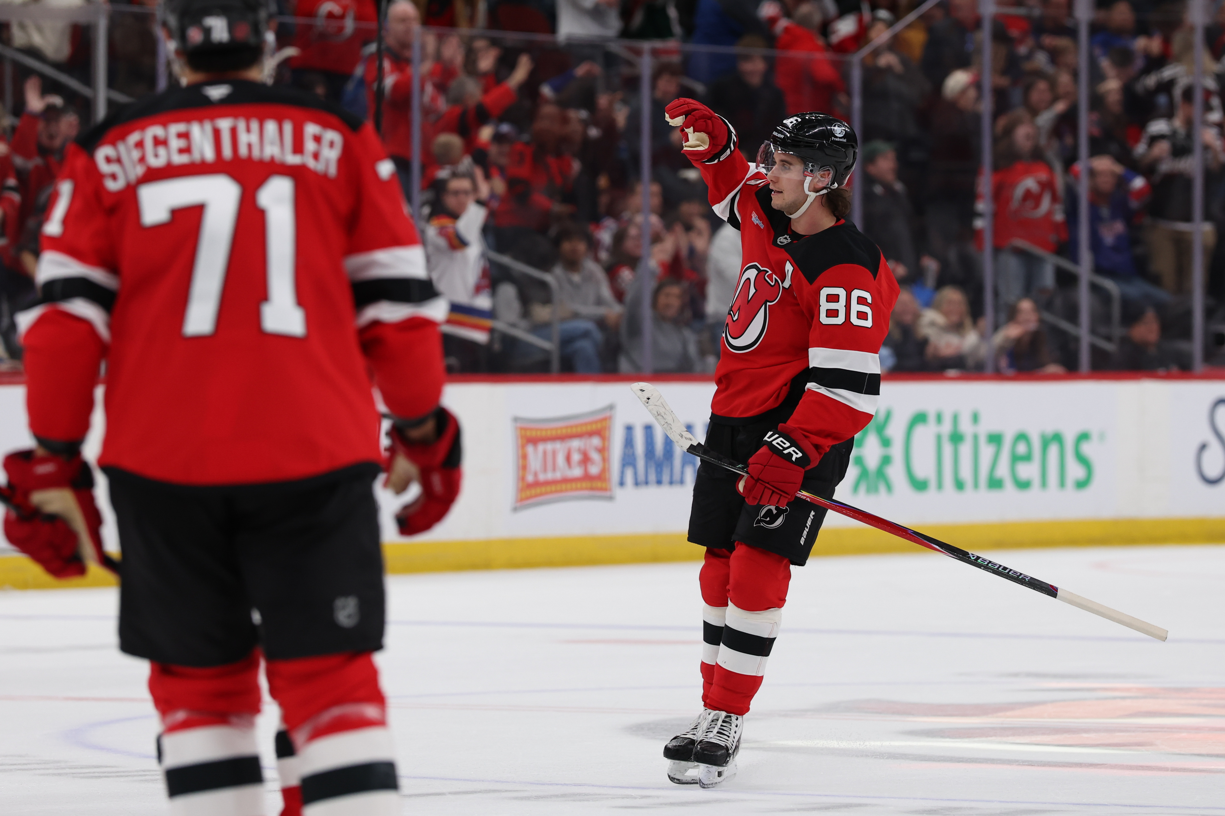 New Jersey Devils center Jack Hughes (86) celebrates his power play goal as we break down our Red Wings vs. Devils prediction & odds.