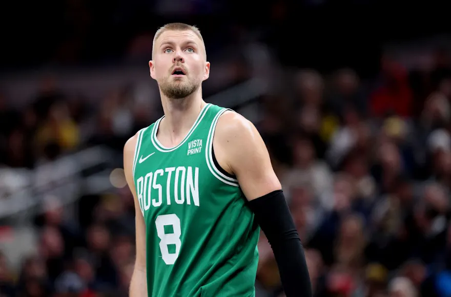 Kristaps Porzingis #8 of the Boston Celtics looks on as we make our Lakers vs. Celtics player props picks and predictions for Thursday's NBA matchup.