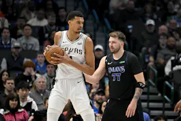 San Antonio Spurs center Victor Wembanyama (1) looks to move the ball past Dallas Mavericks guard Luka Doncic (77), as we examine the NBA MVP opening odds with early predictions and expert picks.