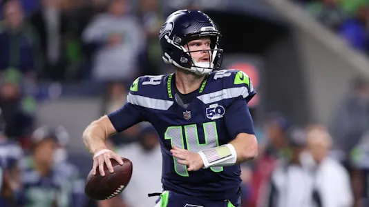 Seattle Seahawks quarterback Sam Darnold, featured in the Seahawks vs. Commanders Prediction, looks to throw a pass against the Houston Texans