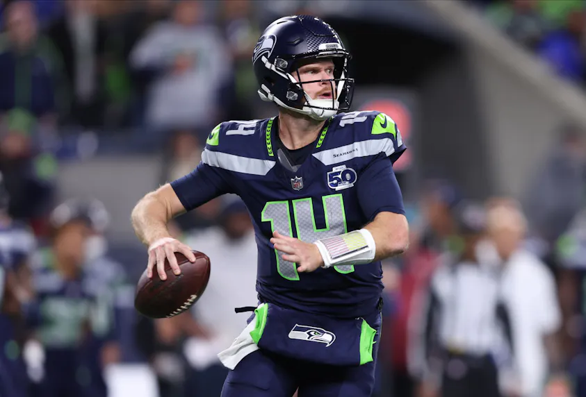 Seattle Seahawks quarterback Sam Darnold, featured in the Seahawks vs. Commanders Prediction, looks to throw a pass against the Houston Texans
