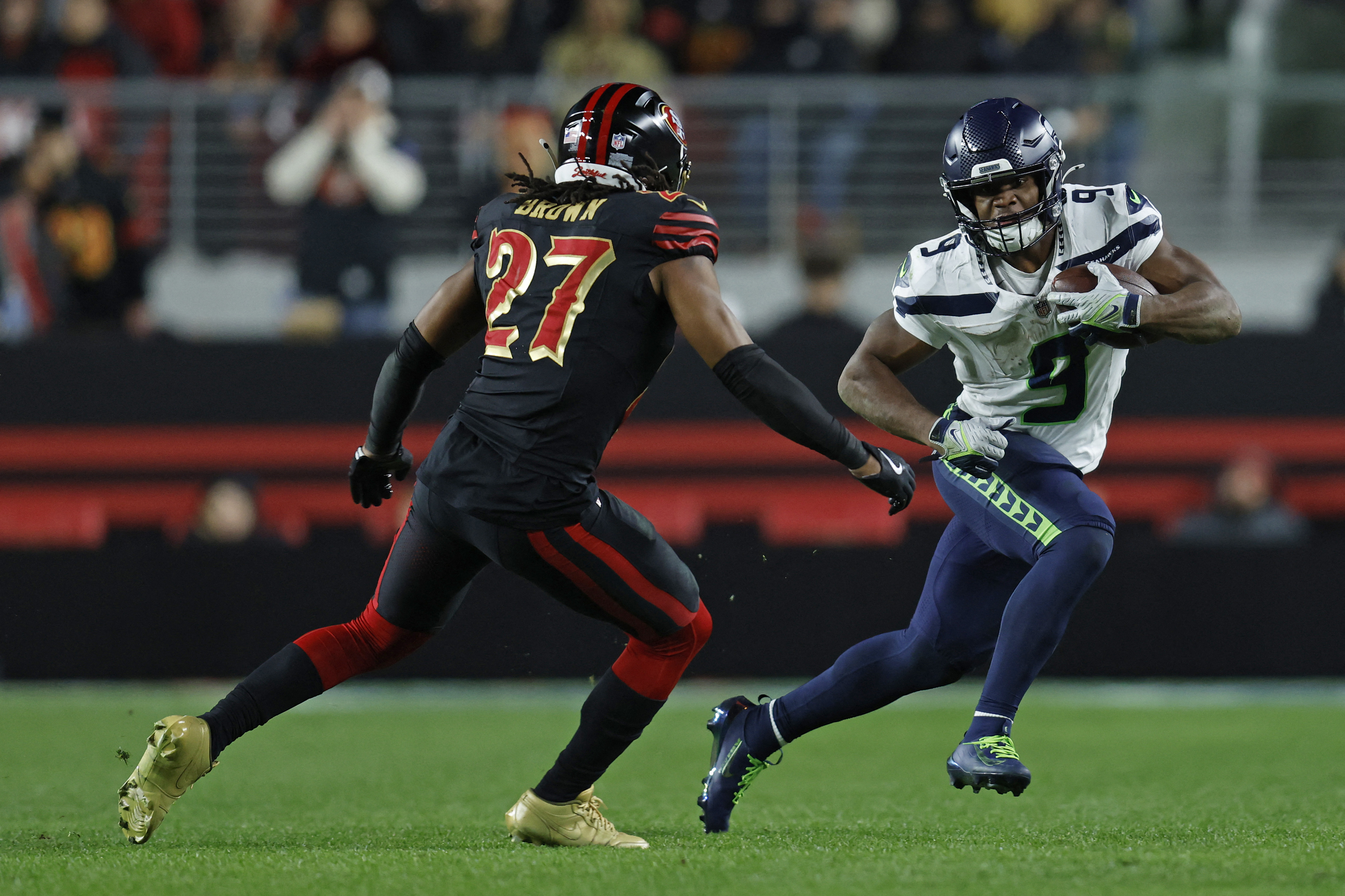 Seattle Seahawks running back Kenneth Walker III (9) rushes the ball against San Francisco 49ers safety Ji'ayir Brown (27) as we make our NFL divisional round predictions.