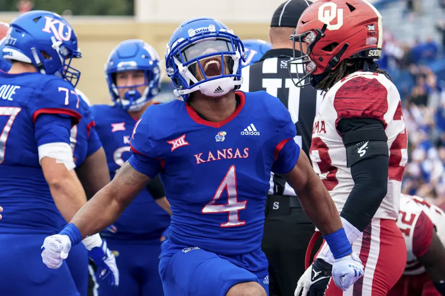 Devin Neal of the Kansas Jayhawks celebrates after scoring a touchdown against the Oklahoma Sooners as we look at our Kansas-UNLV prediction.