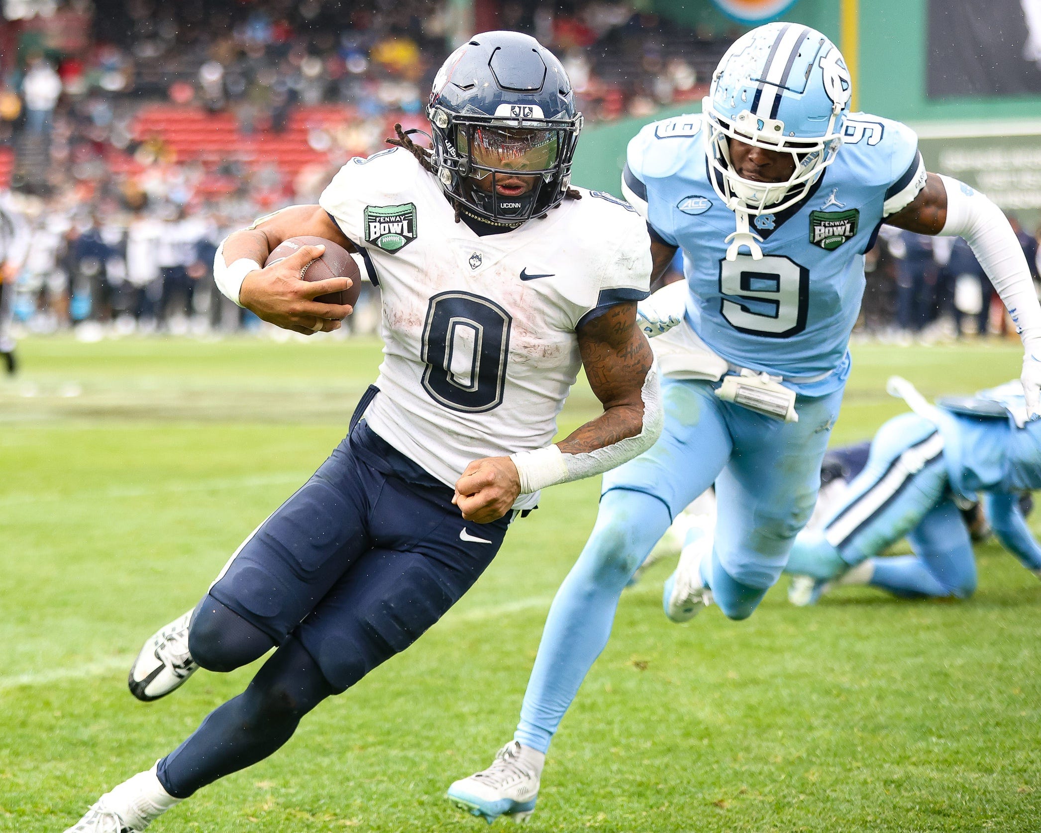 UConn's Cam Edwards carries the ball as we look at our college football opt-out tracker