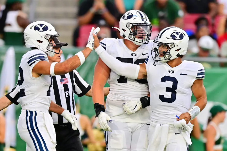 Jaren Hall of the Brigham Young Cougars high fives teammate Puka Nacua after a touchdown in the first quarter against the South Florida Bulls at Raymond James Stadium on September 03, 2022 in Tampa, Florida.