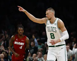 Boston Celtics big Kristaps Porzingis points to a teammate after making a 3-pointer during the first quarter against the Miami Heat, and we offer our top Heat vs. Celtics player props and expert picks based on the best NBA odds.