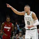 Boston Celtics big Kristaps Porzingis points to a teammate after making a 3-pointer during the first quarter against the Miami Heat, and we offer our top Heat vs. Celtics player props and expert picks based on the best NBA odds.