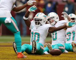 Wide receiver Tyreek Hill #10 of the Miami Dolphins celebrates as we look at the NFL Week 14 odds & betting lines.