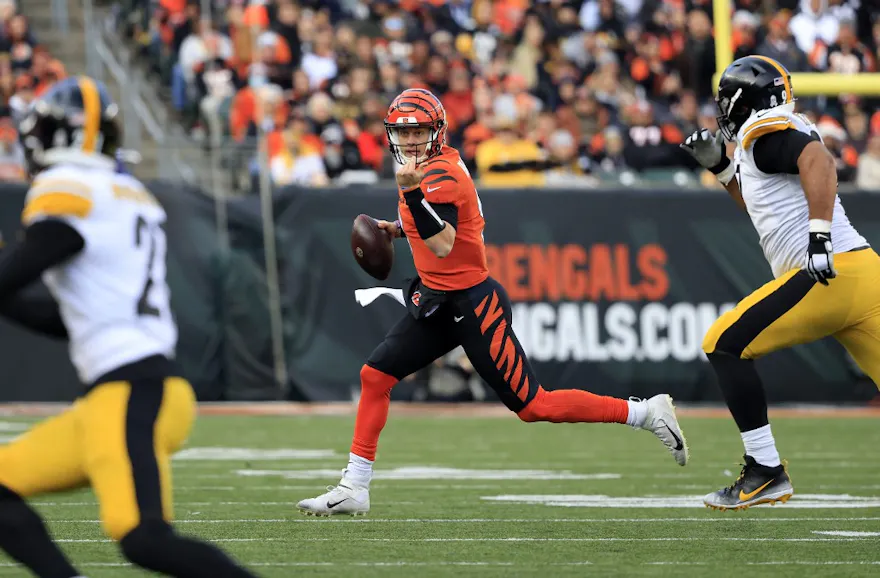 Joe Burrow of the Cincinnati Bengals scrambles with the ball during the second half against the Pittsburgh Steelers at Paul Brown Stadium on November 28, 2021 in Cincinnati, Ohio. Photo by Justin Casterline Getty Images via AFP.