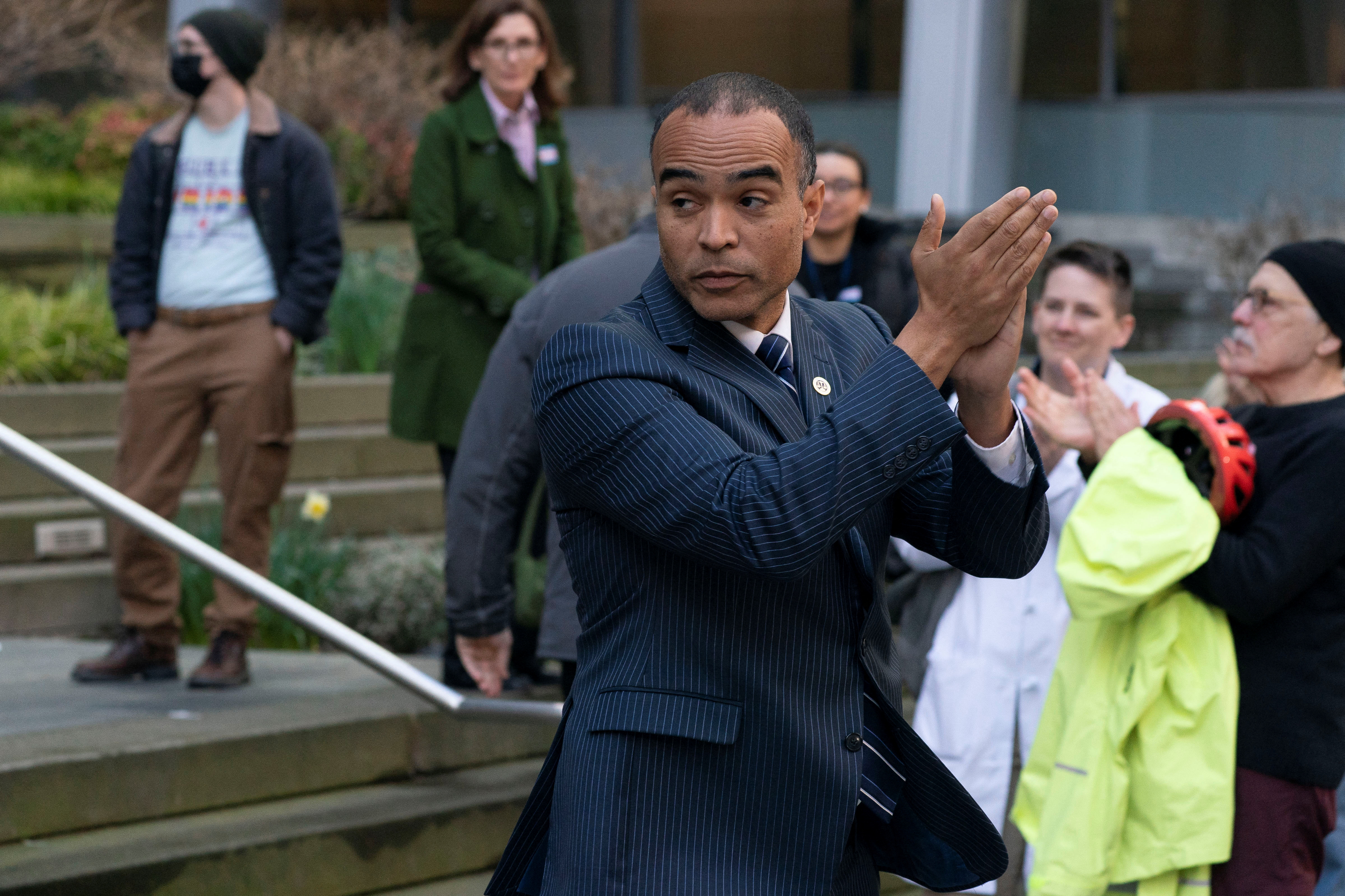 Washington Attorney General Nick Brown claps along with supporters as we look at his statements that Kalshi violates state gambling laws.