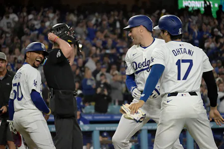 Los Angeles Dodgers first baseman Freddie Freeman is greeted at the plate by shortstop Mookie Betts and designated hitter Shohei Ohtani after hitting a grand slam, and the Dodgers remain the favorites by the latest World Series odds.
