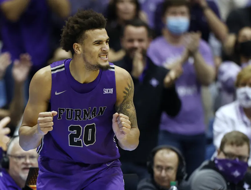 Jalen Slawson #20 of the Furman Paladins reacts after forcing a turnover as we look at why bettors are backing Furman over Virginia in March Madness