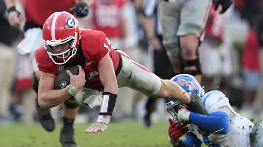 Georgia Bulldogs quarterback Gunner Stockton is brought down as we make our best Georgia vs. Florida early prediction